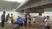 People using nets in flooded river, Philippines