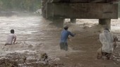 People in flooded river, Philippines