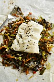 Cod fillet on a bed of wakame vegetables with ginger