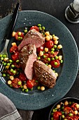 Lamb fillet with fried tomatoes with peas and chickpeas