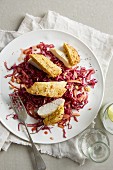 Chicken breast with sweetcorn crust on a bed of red cabbage salad with apple