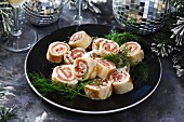 Smoked salmon rolls with fresh cheese for Christmas