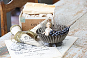 Christmas crib made from cake tin next to cones of old paper