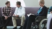 Doctor consulting patient in hospital waiting room