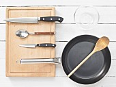 Various kitchen utensils: pan, spoon, knives