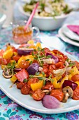 Barbeque of vegetables: red onion, red pepper, tomatoes, fresh thyme, mushrooms and garlic
