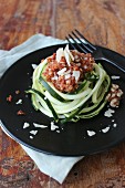 Zucchini noodles with tomatoes, walnuts and parmesan cheese