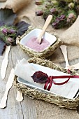 Rustic table decoration with hay trays, wooden cutlery and jute table runners