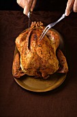 Whole baked turkey being carved