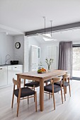 Scandinavian-style wooden chairs and dining table in kitchen