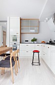 Scandinavian-style wooden chairs and dining table in kitchen