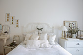 Ornate metal bed in white vintage-style bedroom
