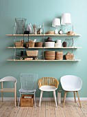 Shelving on blue wall above retro chairs