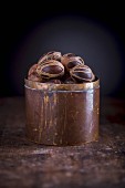 Nutmeg with mace in a copper container