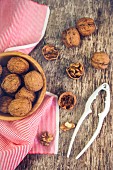 Walnuts with a nutcracker on a wooden background
