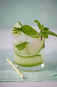 Cucumber and melon water with fresh mint in a glass, close up.