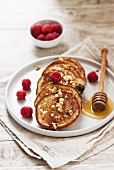Quark and buckwheat pancakes with blueberries, raspberries and a honey nut topping