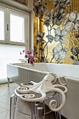 Octopus ornament on transparent stool next to bathtub