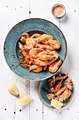 Prepared shrimps on blue plate on wooden background