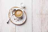 Coffee cup on white wooden background