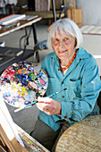 Elderly woman painting