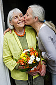 Elderly woman receiving flowers