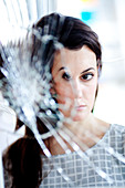Woman in front of a broken mirror