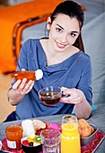 Woman adding honey to infusion
