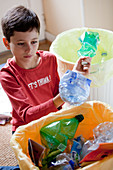 Boy recycling waste