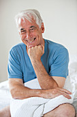 Smiling senior man in bed