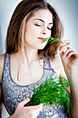 Woman smelling dill