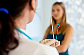 Doctor holding a IUD contraceptive
