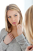 Young woman with finger on lips