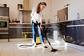 Woman using a steam cleaner