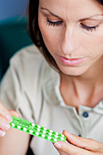 Woman with contraceptive pills