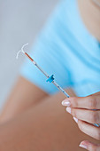 Woman holding IUD