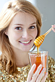 Woman eating honey