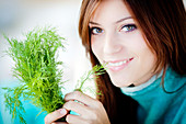 Woman smelling dill