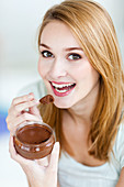 Woman eating a chocolate mousse