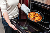 Woman using oven