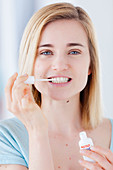 Woman applying a bleaching gel