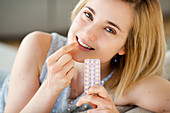 Woman holding contraceptive pills