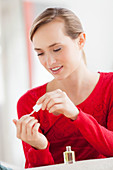 Woman applying polish on nails