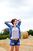 Woman stretching in a field