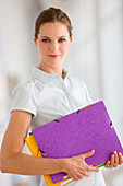 Woman holding some folders