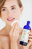 Woman using organic rose water lotion