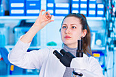 Woman looking at microscope slide