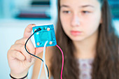 Girl testing proton exchange membrane cell