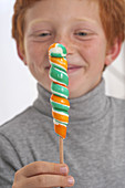 Portrait of a boy holding lollipop