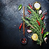 Bunch of spices and old spoon on dark vintage background